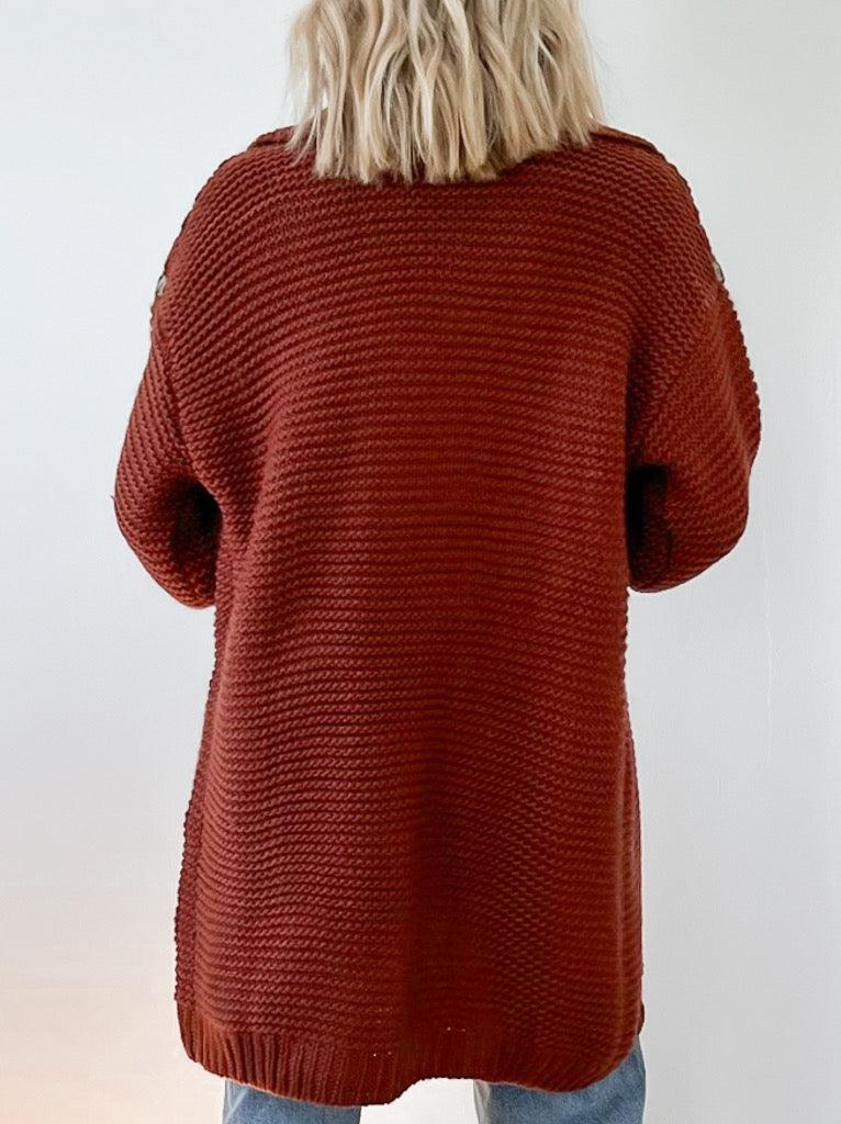 sweater features a chunky knit stitch, with a wide collar and open front design