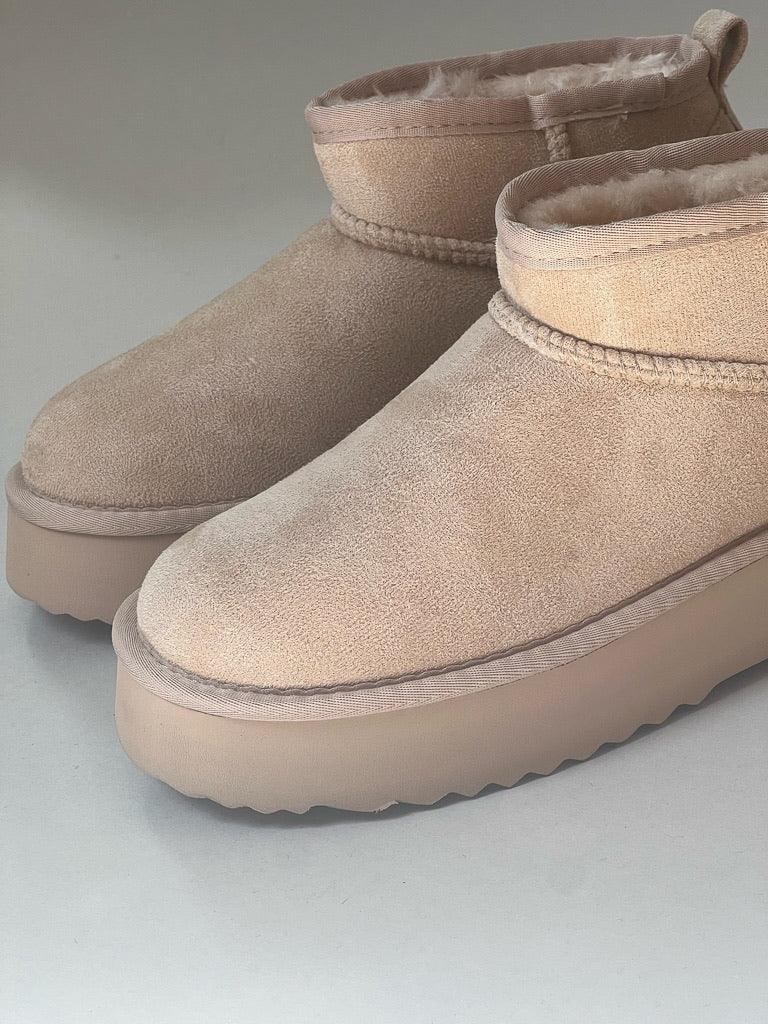 vegan boot featuring a platform and faux fur-lined insole