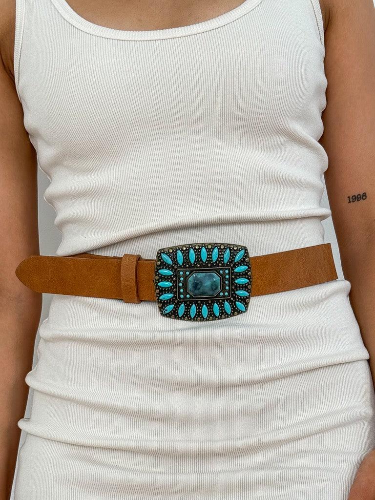 beautiful brass and turquoise buckle in a belt