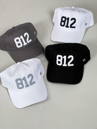 Represent the 812 area code in the charcoal with white stitch hat. with color options